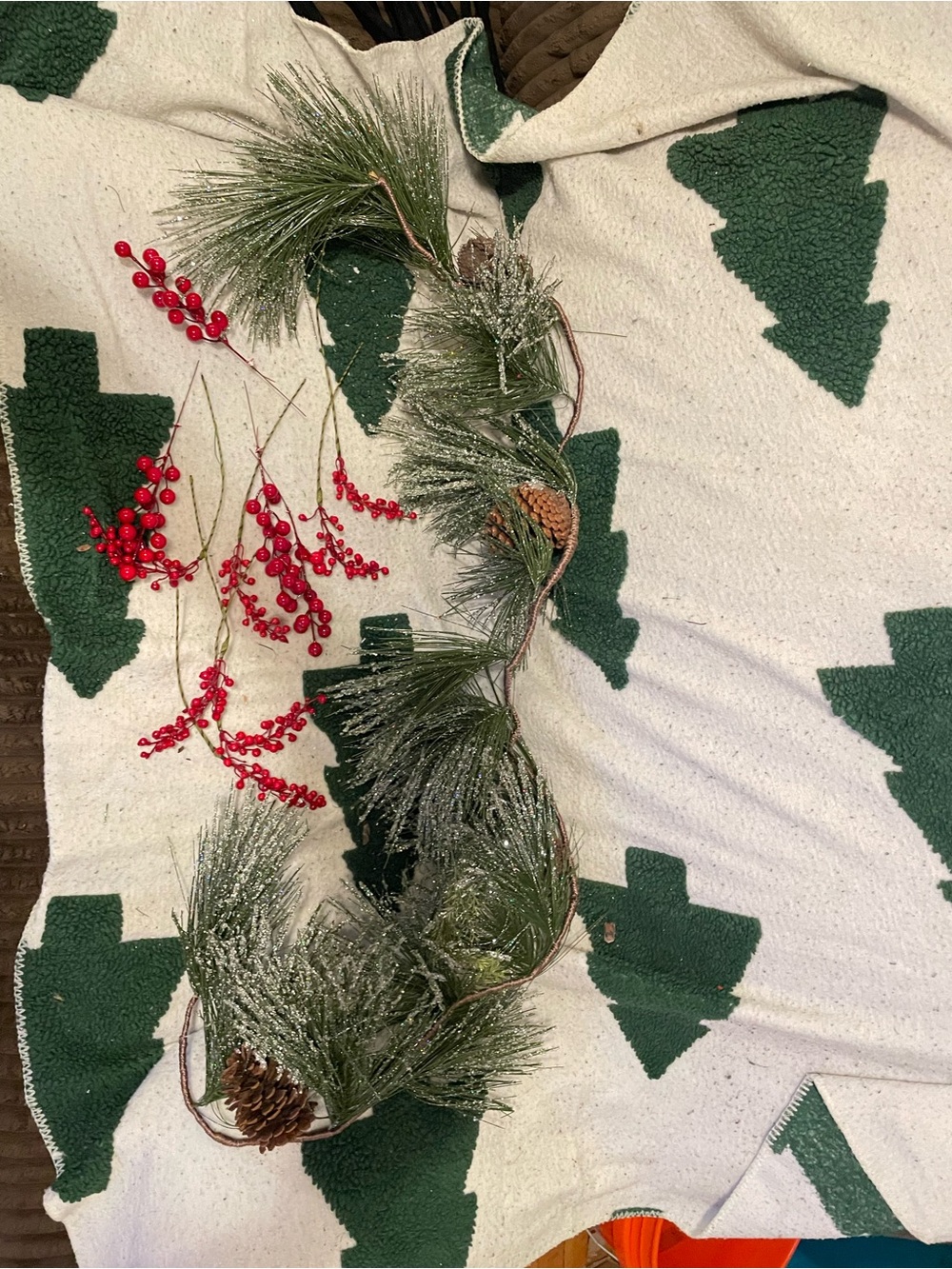 Holiday Pine and Berry Garland with sprigs of holly and red light string-